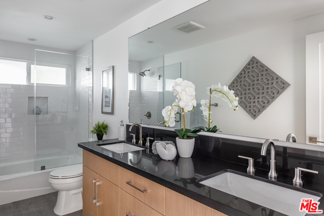 2048 Commodore Road Newport Beach, CA 92660 - Photo 17 of 39 a bathroom with a granite countertop sink a toilet and shower