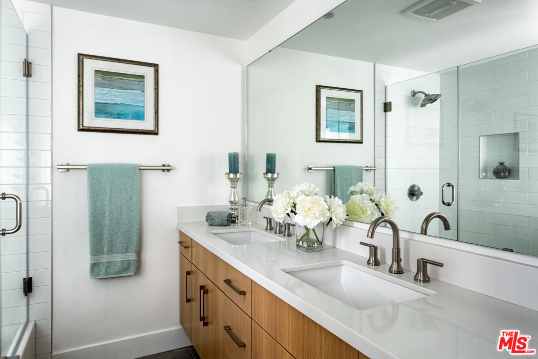 2048 Commodore Road Newport Beach, CA 92660 - Photo 19 of 39 a bathroom with double vanity sinks a shower and a mirror