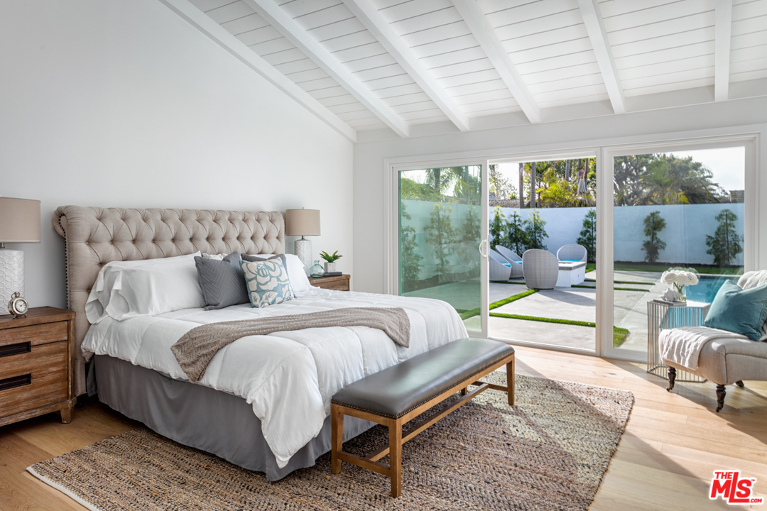 2048 Commodore Road Newport Beach, CA 92660 - Photo 21 of 39 a spacious bedroom with a bed a couch and large window with outer view