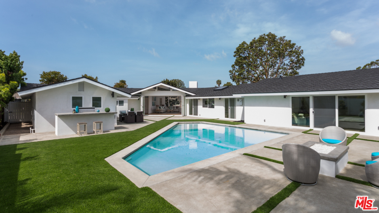 2048 Commodore Road Newport Beach, CA 92660 - Photo 27 of 39 a view of a house with a swimming pool and sitting area