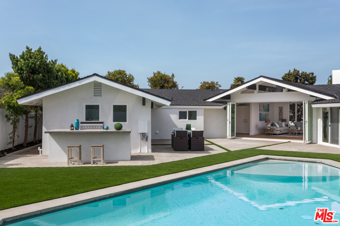 2048 Commodore Road Newport Beach, CA 92660 - Photo 30 of 39 a view of house with yard outdoor seating and swimming pool