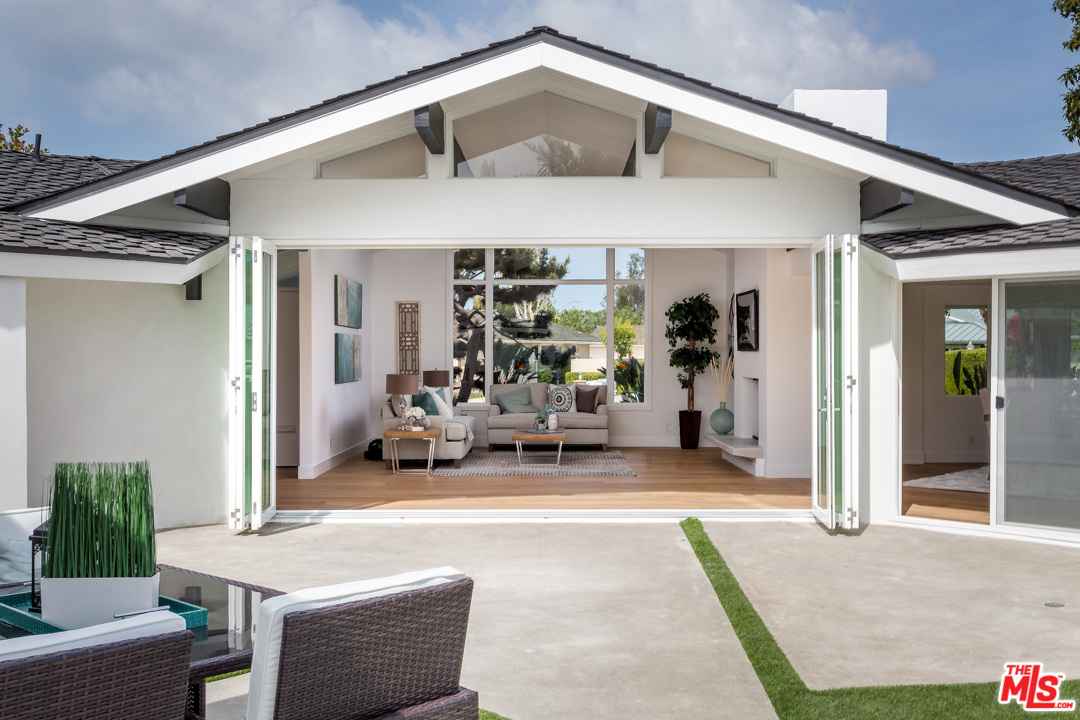 2048 Commodore Road Newport Beach, CA 92660 - Photo 4 of 39 a view of a patio with table and chairs in front of house