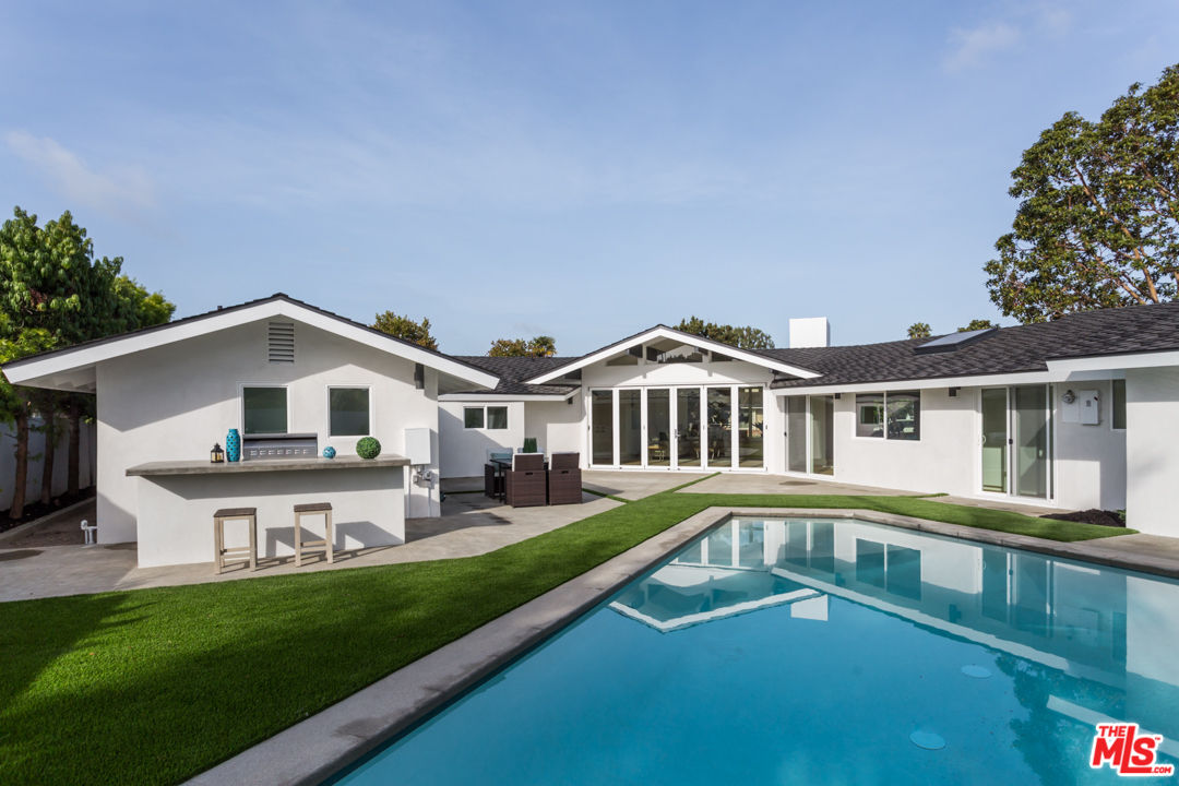 2048 Commodore Road Newport Beach, CA 92660 - Photo 32 of 39 a front view of a house with a yard table and chairs