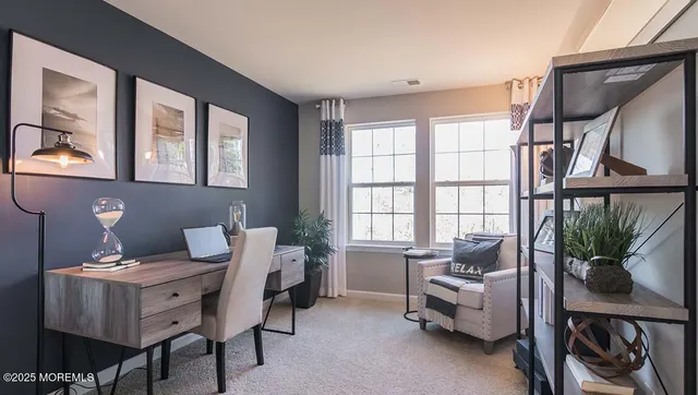 a view of a livingroom with furniture and a window