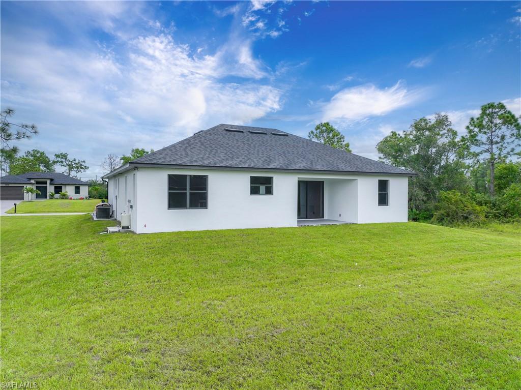 3908 Sunset Road Lehigh Acres, FL 33971 - Photo 29 of 30 a view of a house with a backyard
