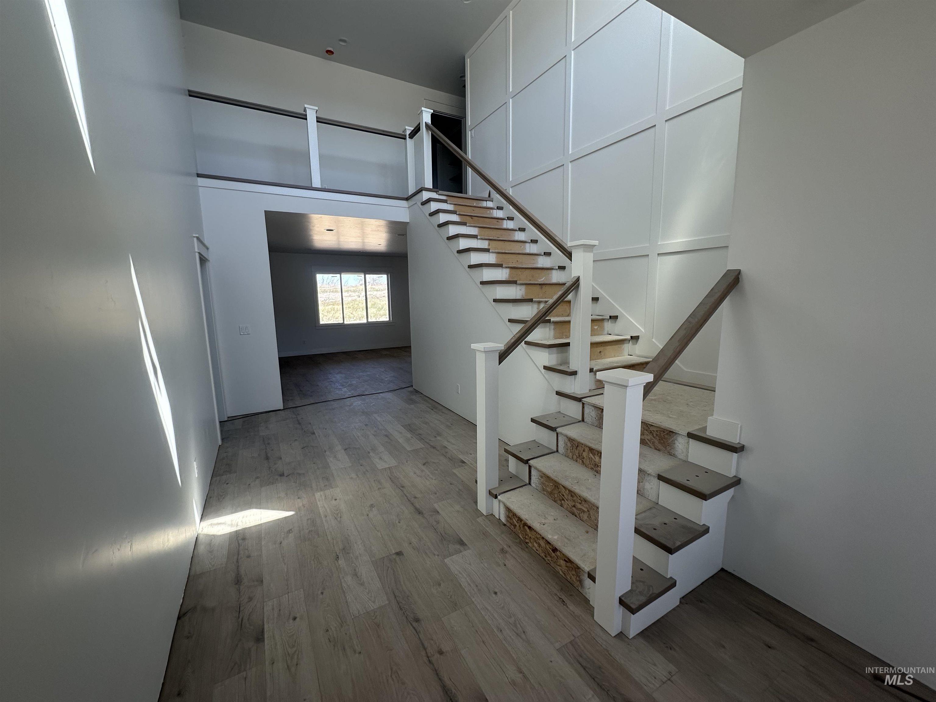 3035 Lake View Twin Falls, ID 83301 - Photo 2 of 18 Two-story foyer featuring a prominent staircase with white newel posts and dark wood-finish handrails