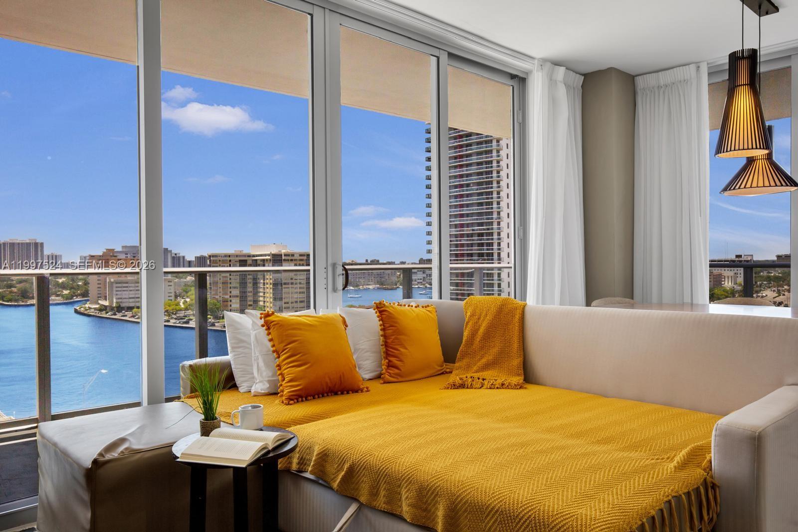 a blue bed sitting in front of a window
