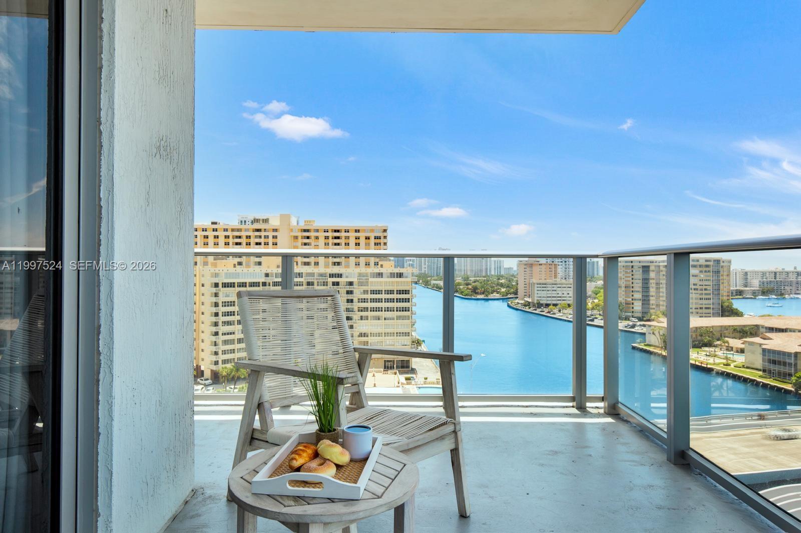 4010 South Ocean Drive, Unit R708 Hollywood, FL 33019 - Photo 14 of 35 a view of a balcony with dining table and chairs