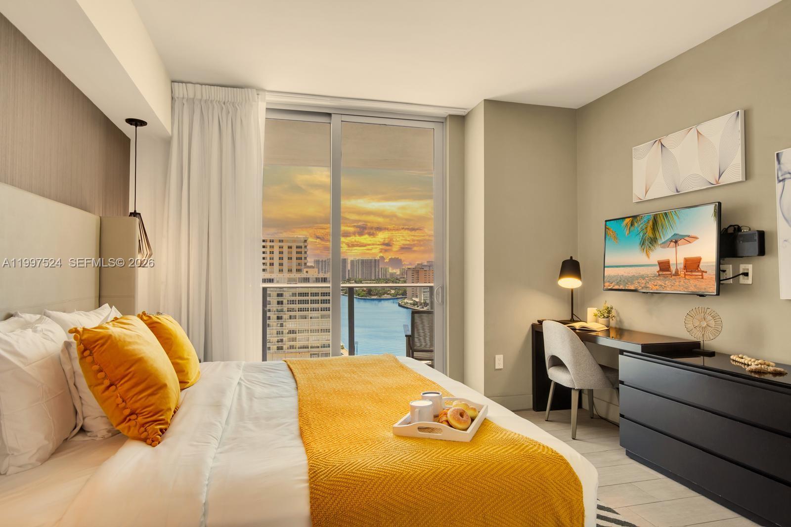 4010 South Ocean Drive, Unit R708 Hollywood, FL 33019 - Photo 29 of 35 a bedroom with a bed and wooden floor