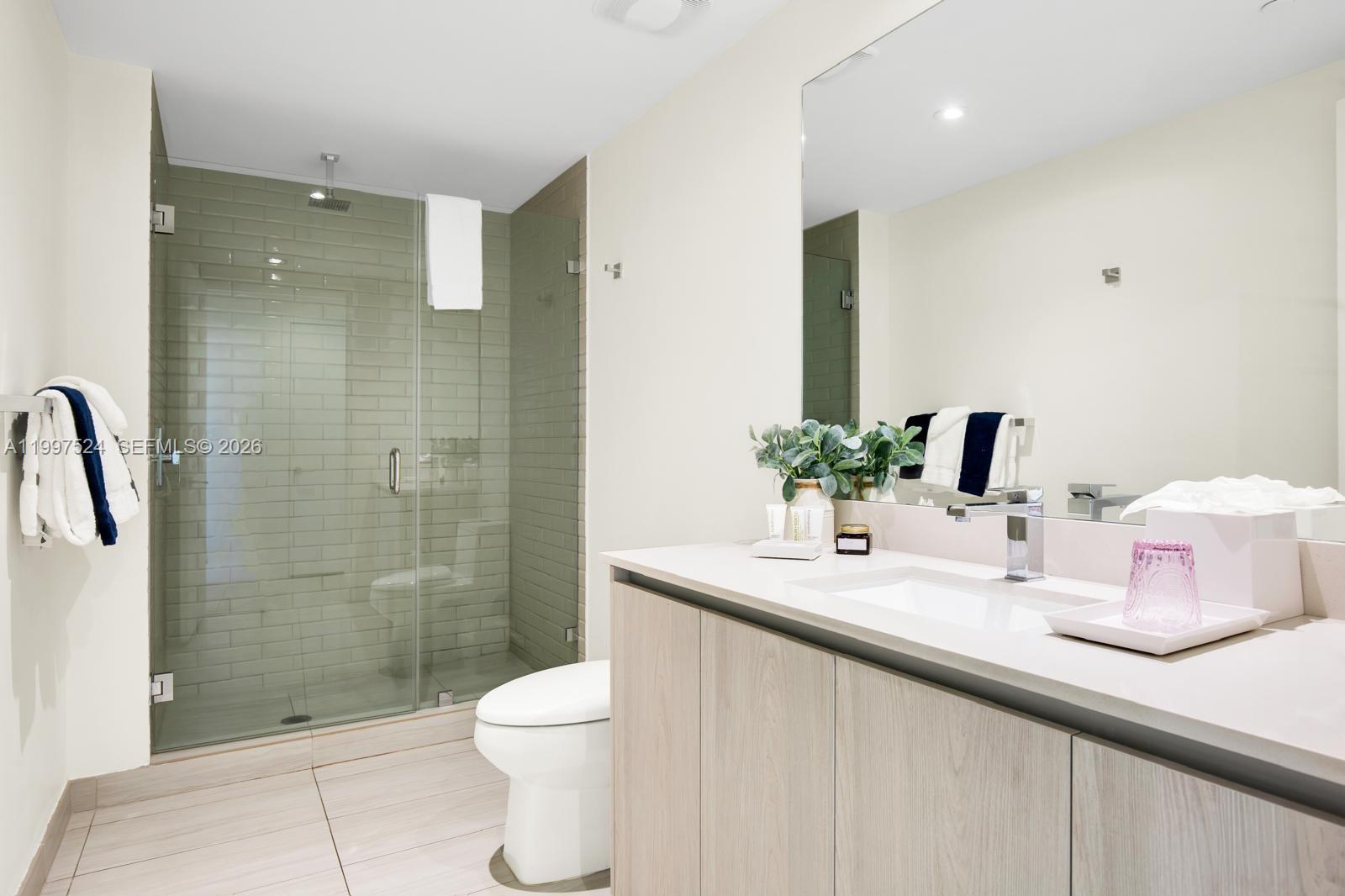4010 South Ocean Drive, Unit R708 Hollywood, FL 33019 - Photo 31 of 35 a bathroom with a sink a toilet and shower