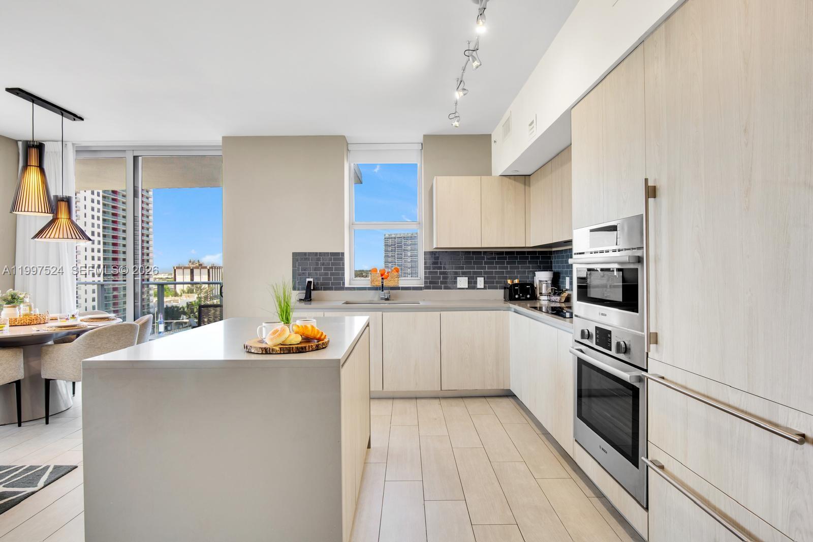 4010 South Ocean Drive, Unit R708 Hollywood, FL 33019 - Photo 5 of 35 a kitchen with stainless steel appliances a stove a sink and a refrigerator