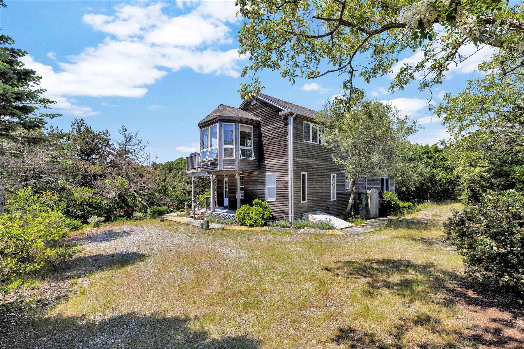 3 Amber Way Truro, MA 02666 - Photo 1 of 43 a front view of a house with a yard