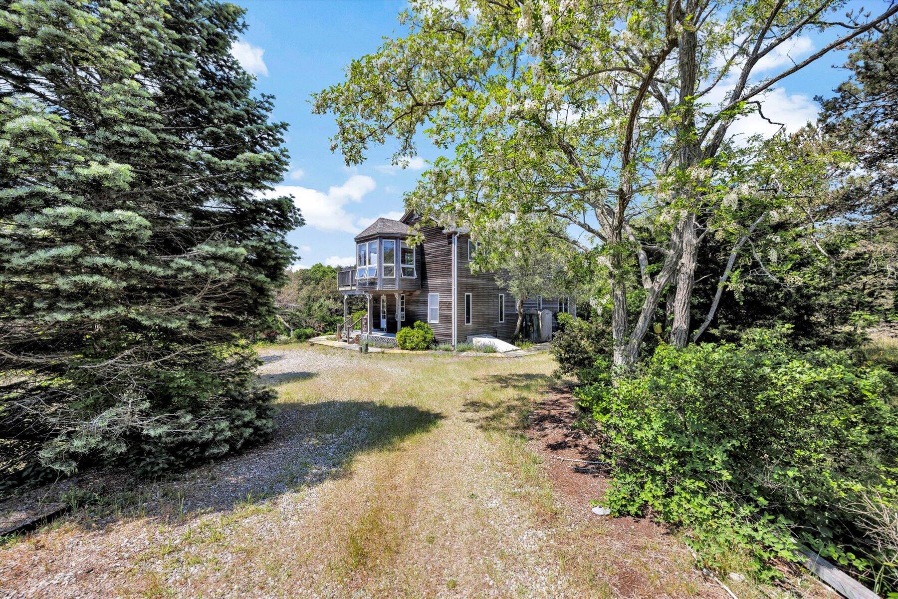 3 Amber Way Truro, MA 02666 - Photo 2 of 43 a view of a house with large trees and plants