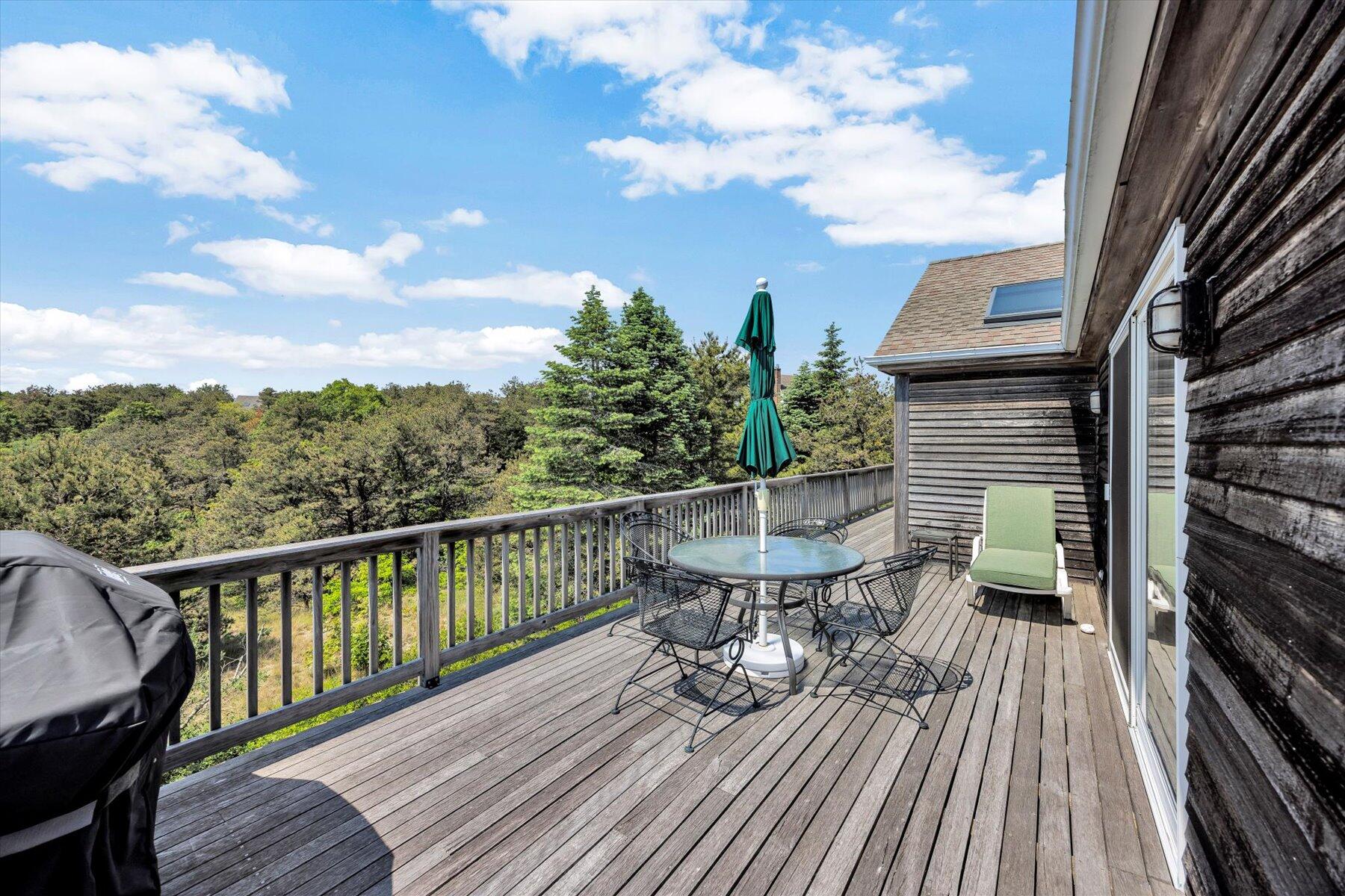 3 Amber Way Truro, MA 02666 - Photo 27 of 43 a balcony with wooden floor table and chairs