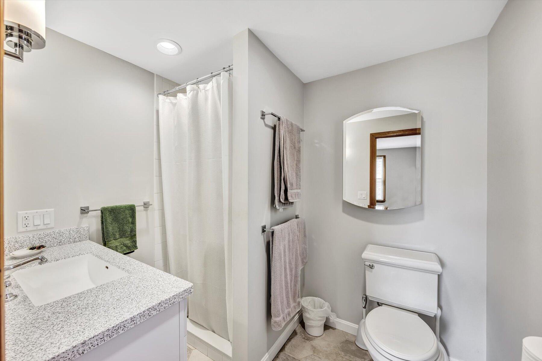 3 Amber Way Truro, MA 02666 - Photo 33 of 43 a bathroom with a granite countertop toilet sink and mirror