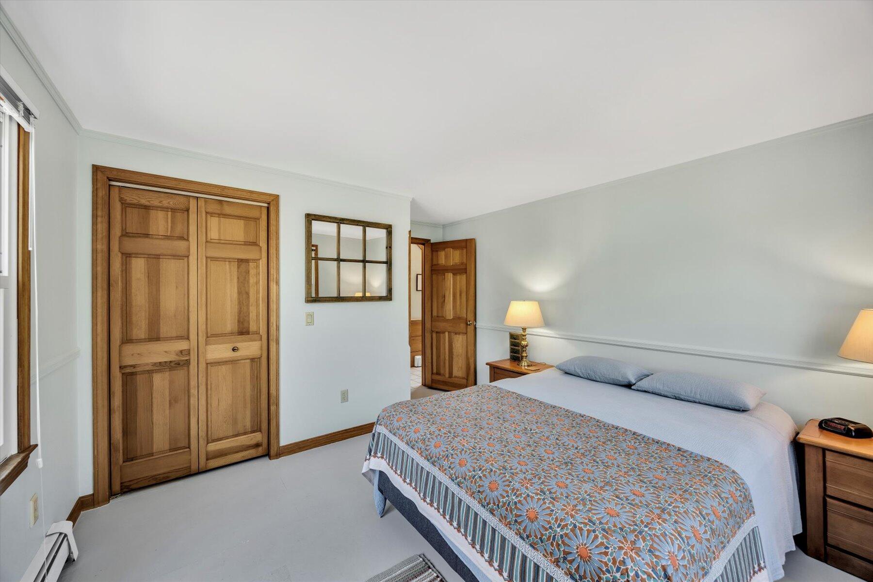 3 Amber Way Truro, MA 02666 - Photo 35 of 43 a bedroom with a bed and closet with mirror