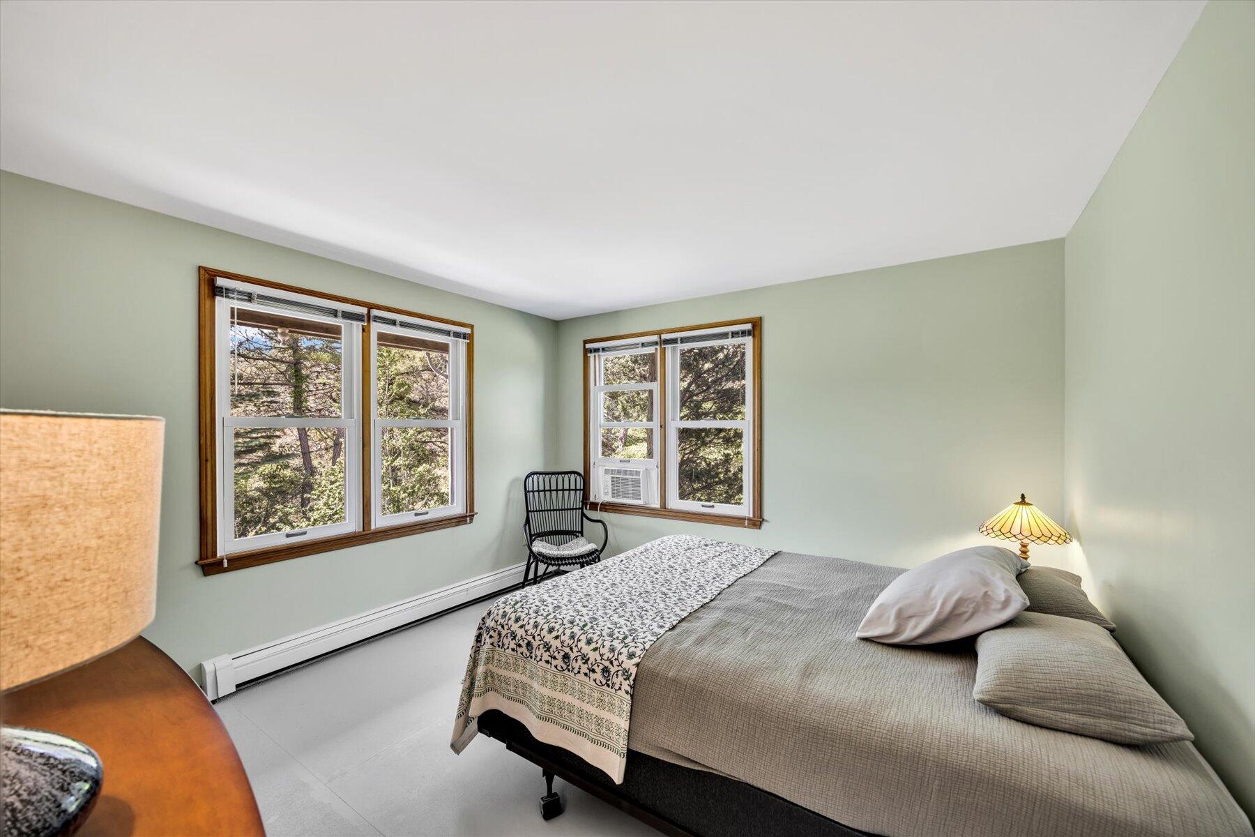 3 Amber Way Truro, MA 02666 - Photo 37 of 43 a bedroom with a bed and wooden floor