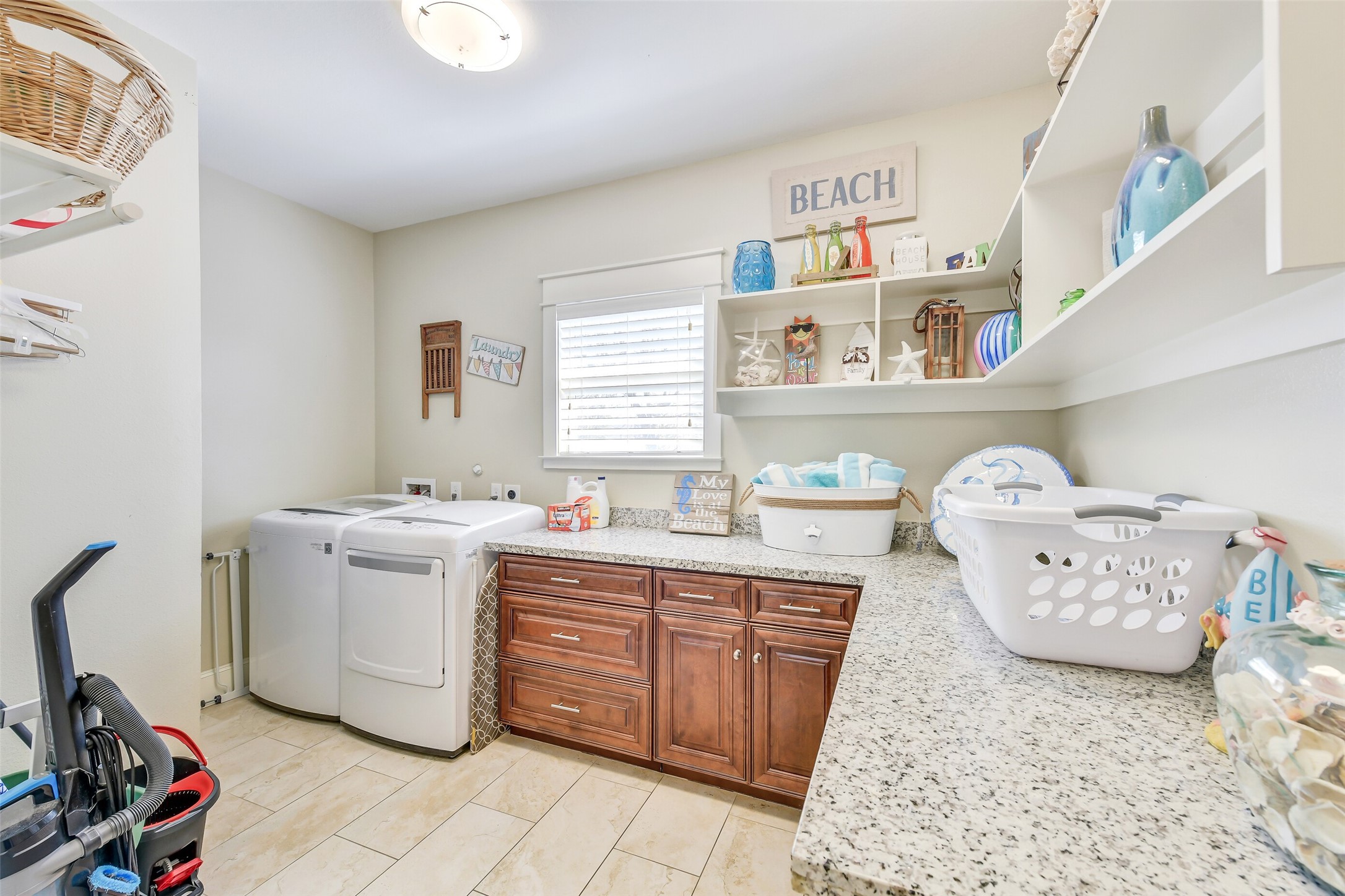3807 Avenue R Galveston, TX 77550 - Photo 12 of 46 Spacious and functional, the laundry room features abundant cabinetry, extra storage, ample work space, and enough space for a secondary refrigerator.