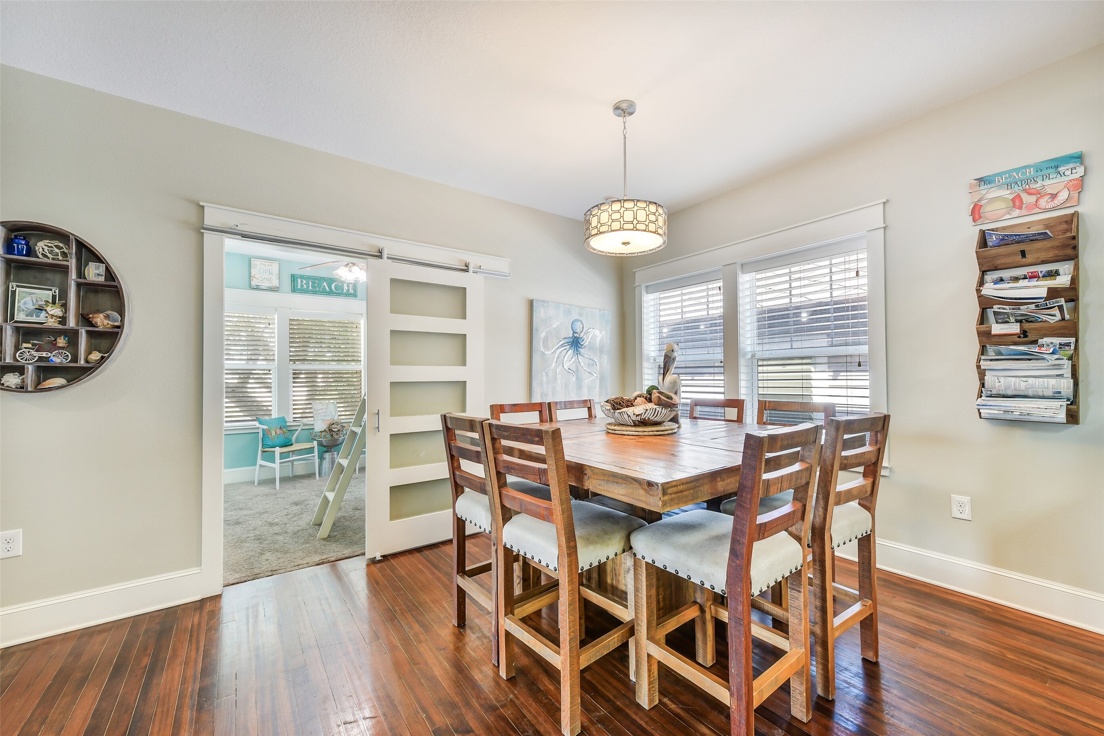 3807 Avenue R Galveston, TX 77550 - Photo 16 of 46 The dining area, located just off the living and kitchen spaces, currently accommodates a table for 8. The room behind this area is the first of two bedrooms, situated on the northeast side of the home.