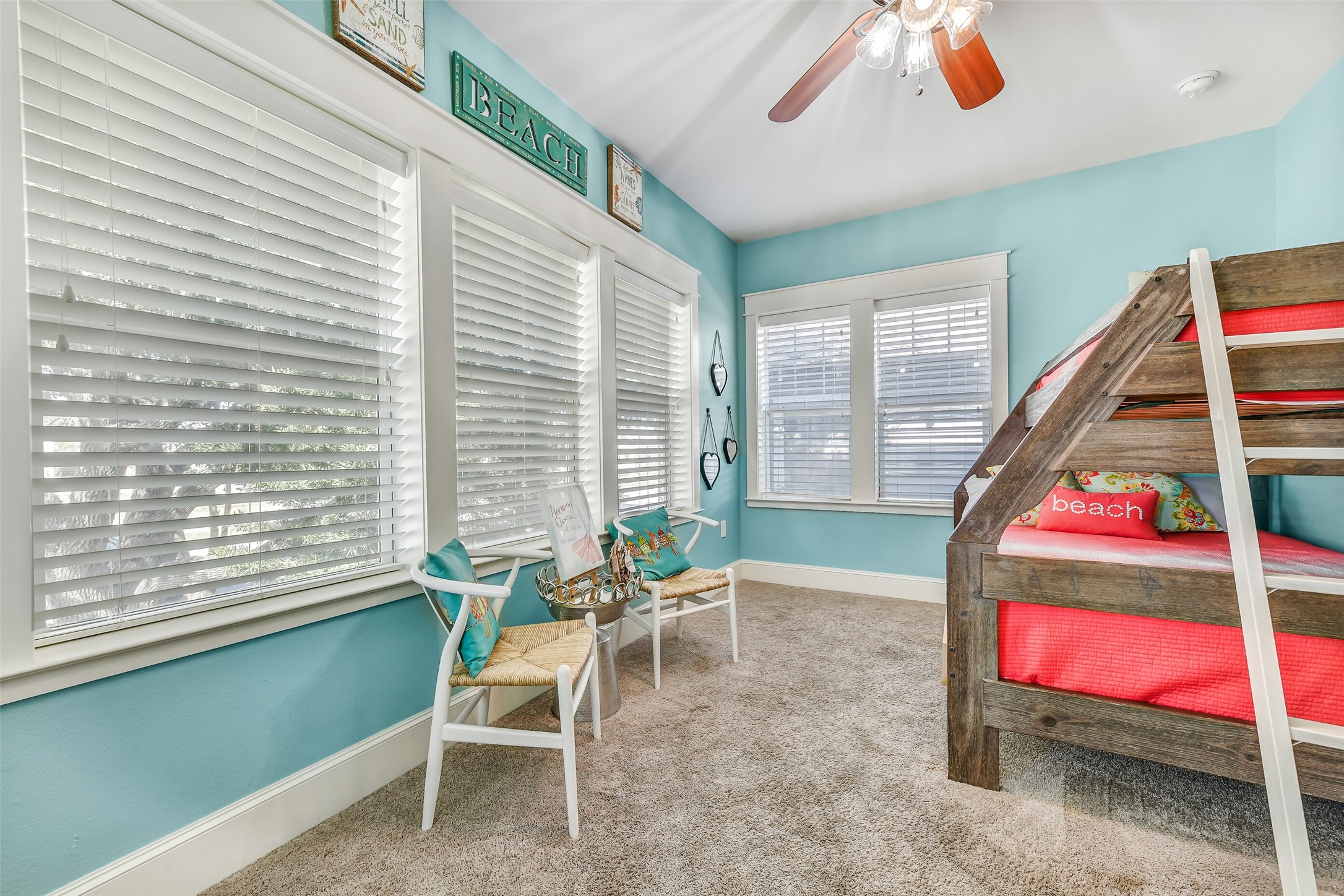 3807 Avenue R Galveston, TX 77550 - Photo 18 of 46 Located off the dining room is the first of three bedrooms, featuring walls of windows and the only carpeted flooring in the home.