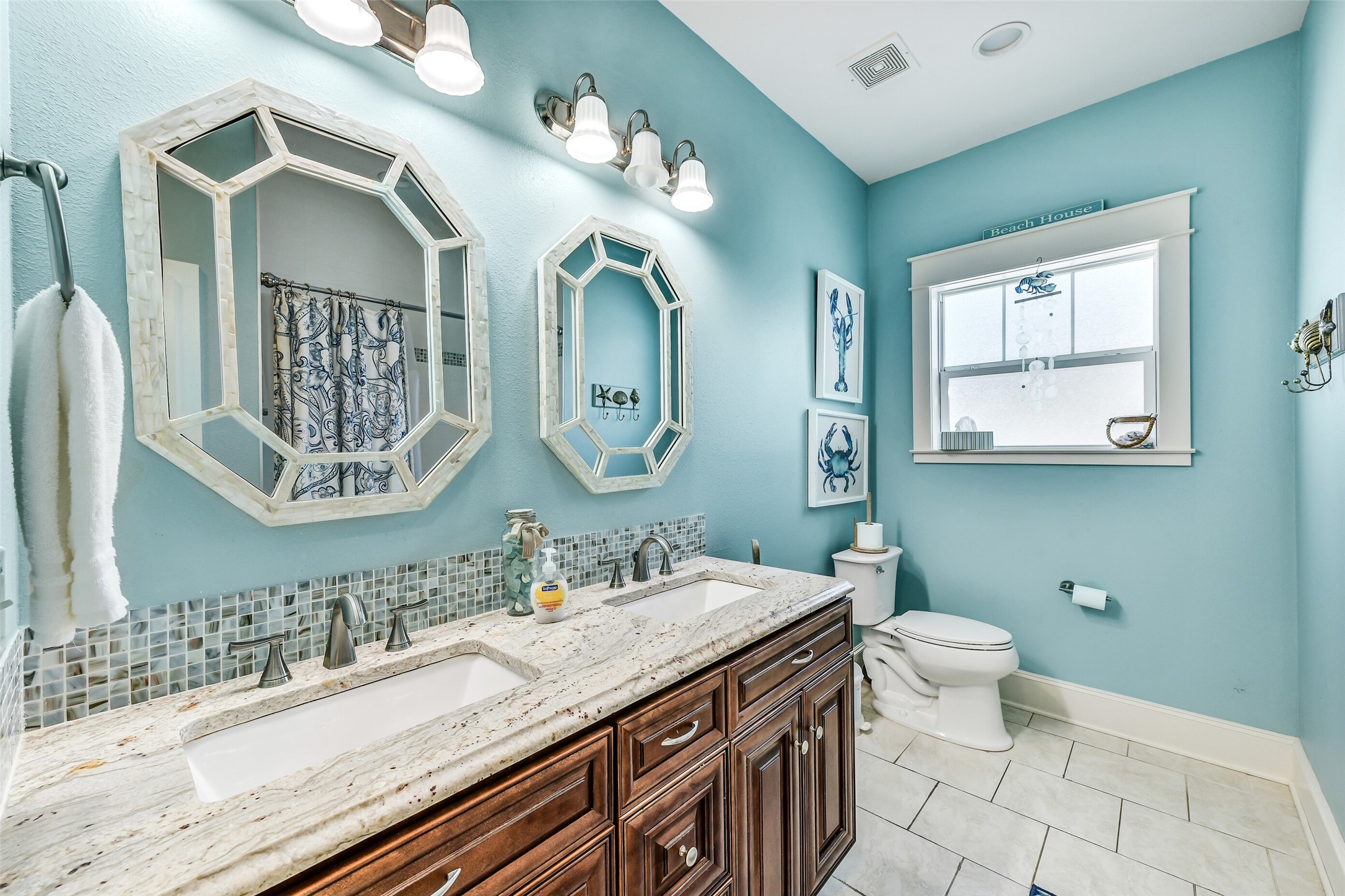 3807 Avenue R Galveston, TX 77550 - Photo 23 of 46 The expansive guest bathroom offers a large vanity with double sinks, granite countertops, and gorgeous fixtures.