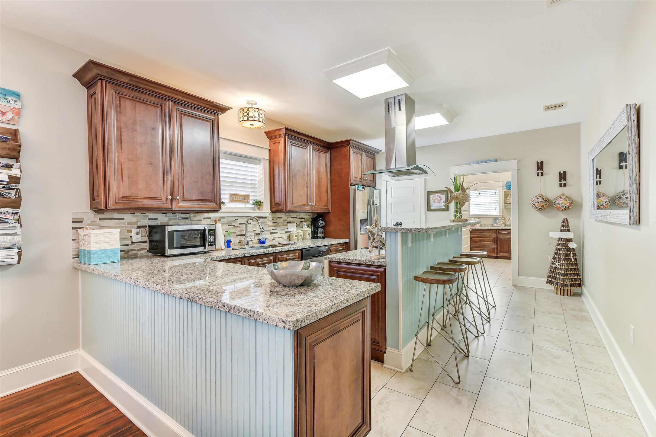 3807 Avenue R Galveston, TX 77550 - Photo 10 of 46 Setup for entertaining, the kitchen offers abundant cabinetry, granite countertops, and expansive prep and cooking space.