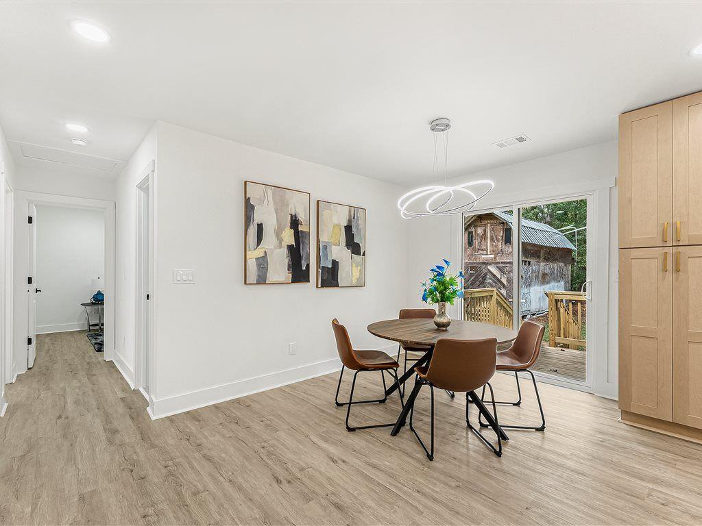 531 Carlton Road Palmetto, GA 30268 - Photo 16 of 38 a view of a dining room with furniture and wooden floor