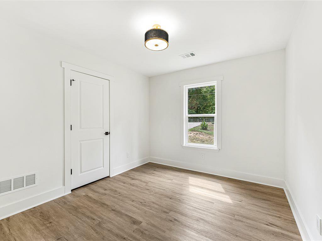 531 Carlton Road Palmetto, GA 30268 - Photo 19 of 38 an empty room with wooden floor and windows