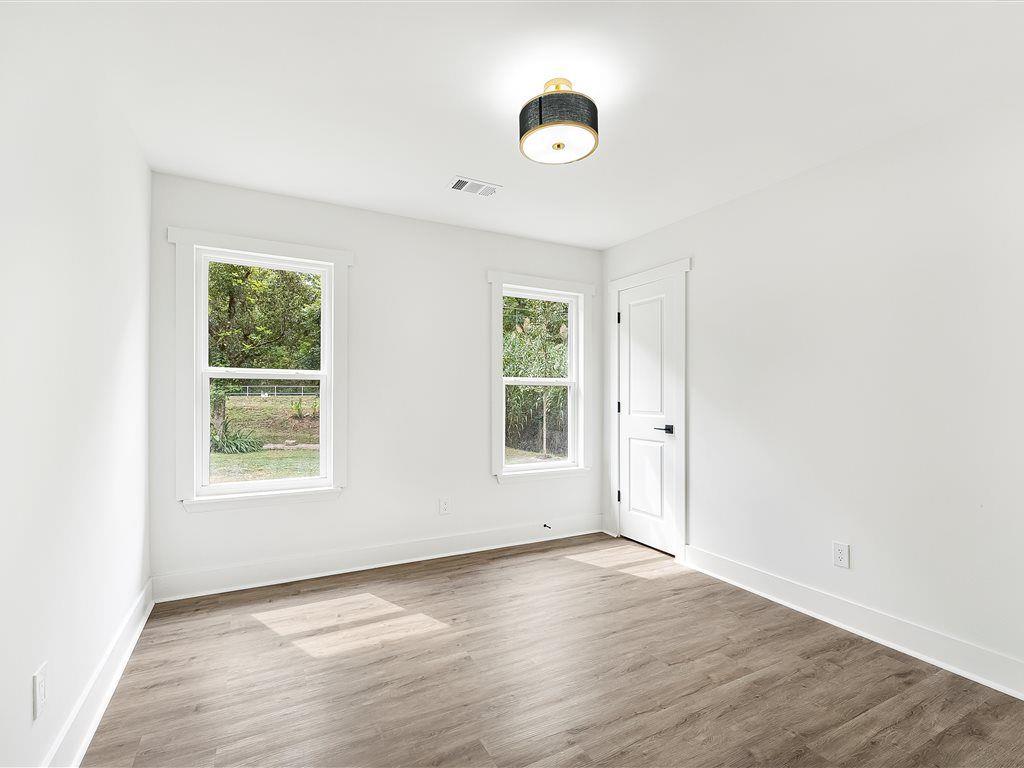 531 Carlton Road Palmetto, GA 30268 - Photo 21 of 38 an empty room with wooden floor and windows