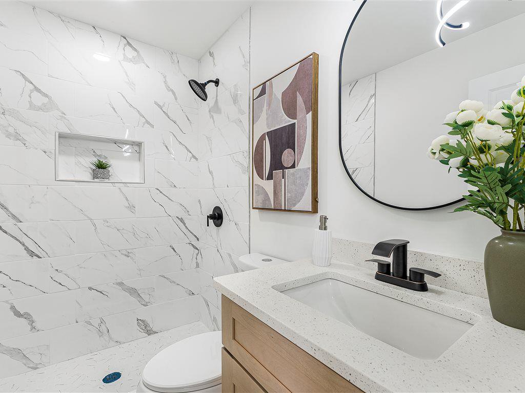 531 Carlton Road Palmetto, GA 30268 - Photo 27 of 38 a bathroom with a sink a toilet and a mirror