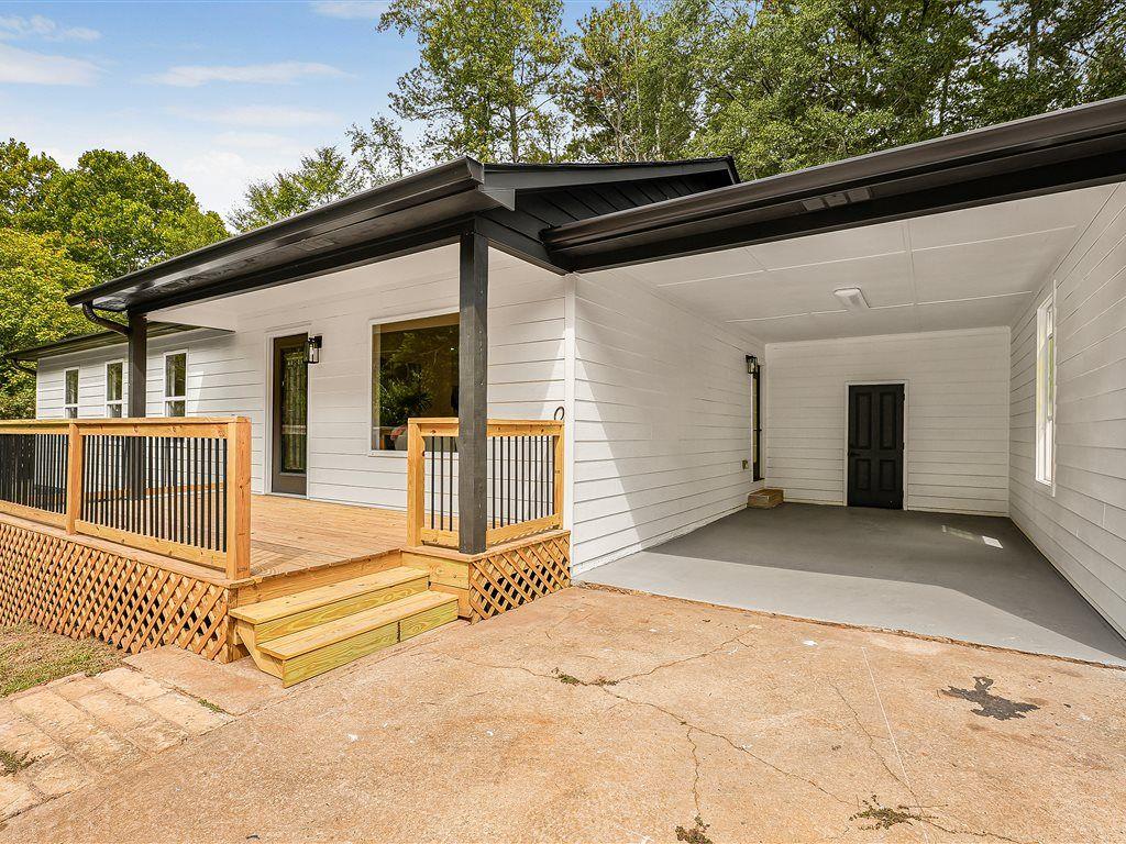 531 Carlton Road Palmetto, GA 30268 - Photo 3 of 38 a view of a house with a small yard and wooden fence