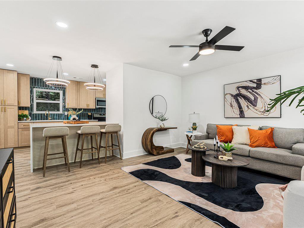 531 Carlton Road Palmetto, GA 30268 - Photo 4 of 38 a kitchen with stainless steel appliances granite countertop a stove top oven a sink dishwasher and white cabinets with wooden floor