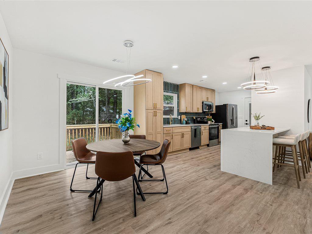 531 Carlton Road Palmetto, GA 30268 - Photo 10 of 38 a kitchen with kitchen island a dining table and chairs