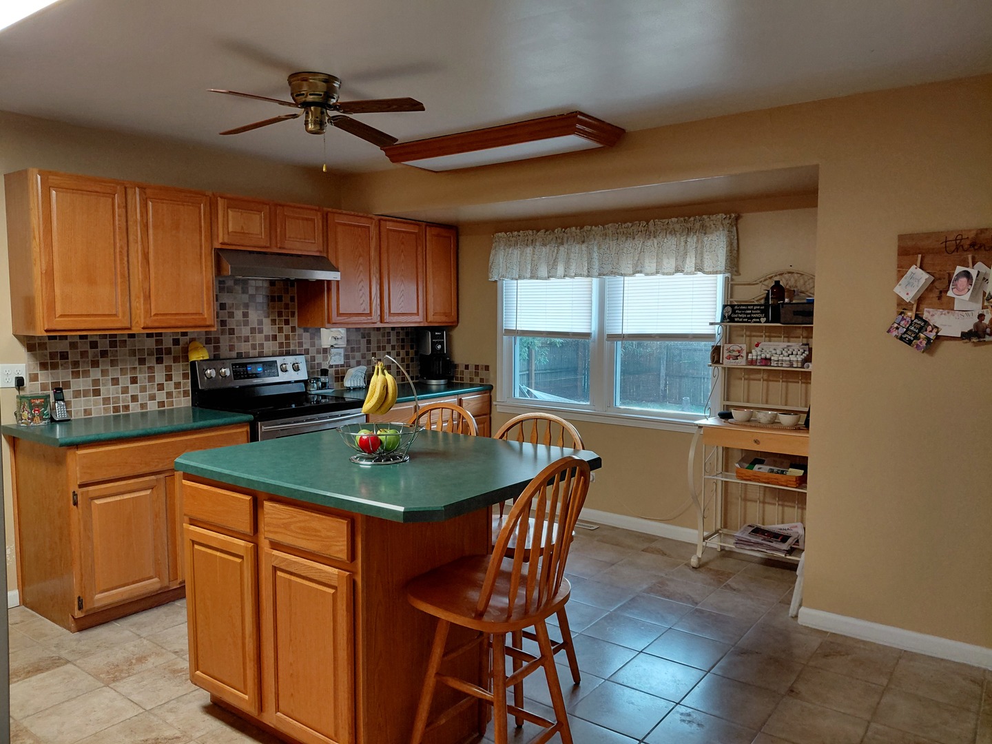 827 South McKinley Avenue Kankakee, IL 60901 - Photo 4 of 13 a kitchen with stainless steel appliances granite countertop a sink a stove and a refrigerator