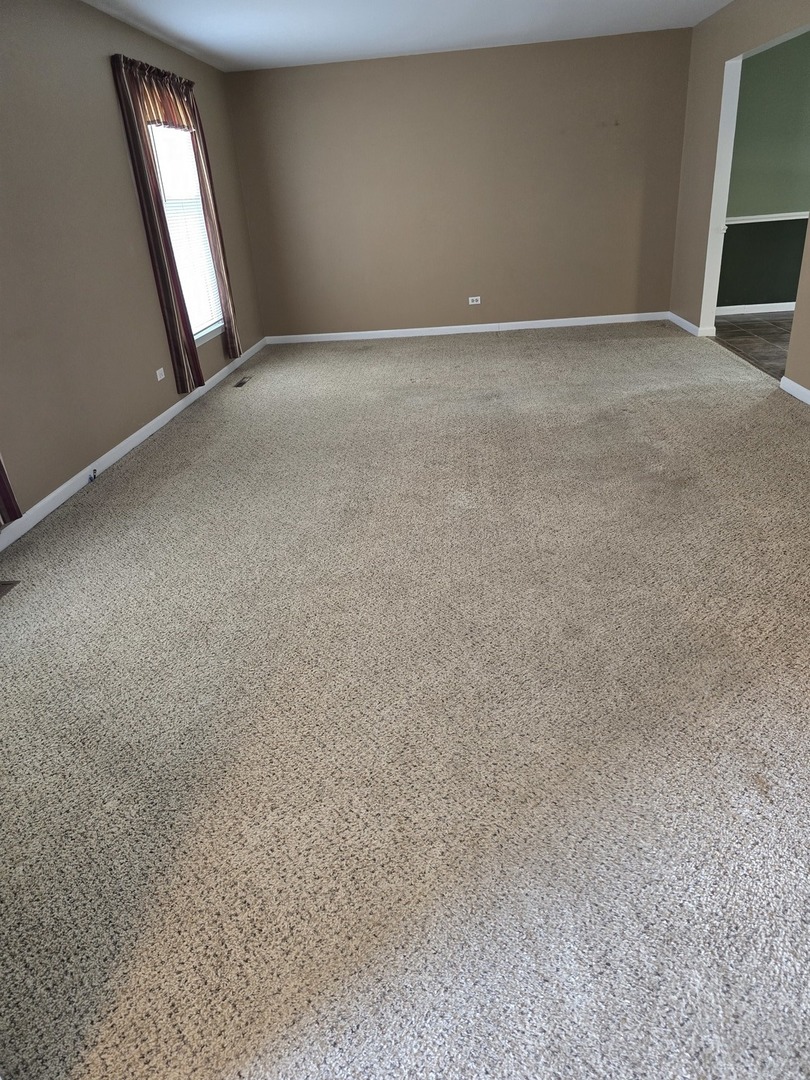 827 South McKinley Avenue Kankakee, IL 60901 - Photo 6 of 13 an empty room with stairs and closet area