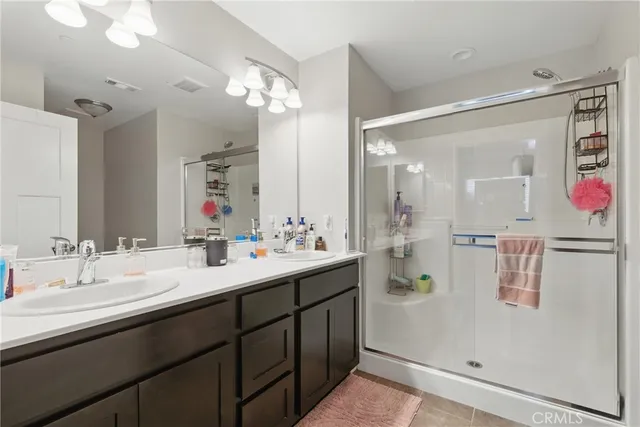 a bathroom with a double vanity sink mirror and