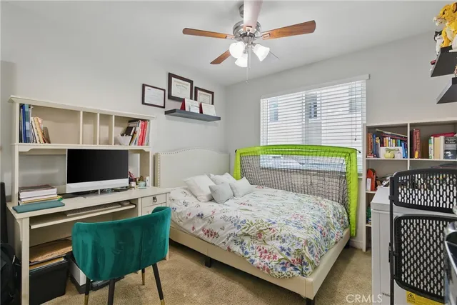 a bedroom with a bed window and a table