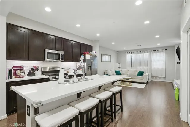 a kitchen with counter space dining table and chairs