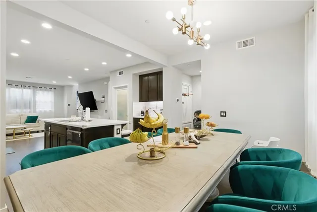 a view of a dining room with furniture and a kitchen