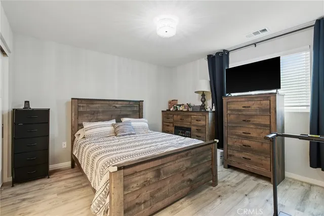 a bedroom with a bed and a television