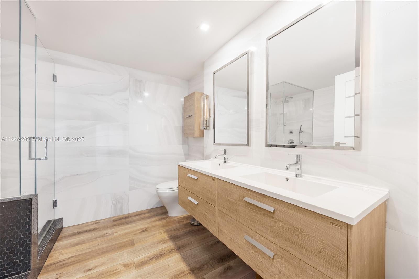 2451 Brickell Avenue, Unit 21D Miami, FL 33129 - Photo 16 of 21 a spacious bathroom with a bathtub shower sink and mirror