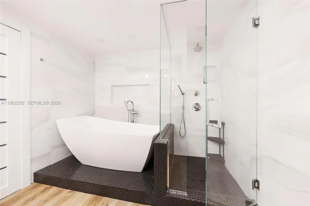 a bathroom with a bathtub and a shower