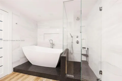 a bathroom with a bathtub and a shower