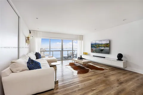 a living room with furniture window and a flat screen tv