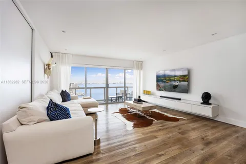 a living room with furniture window and a flat screen tv