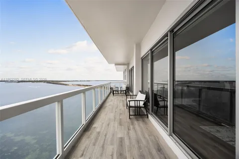 a view of balcony with couch and wooden floor