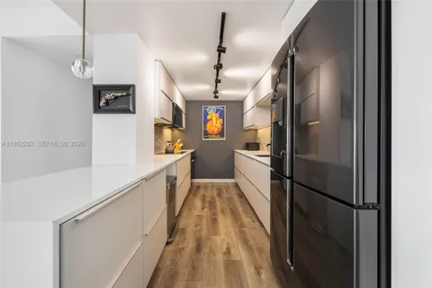 a kitchen with stainless steel appliances granite countertop refrigerator a sink and dishwasher