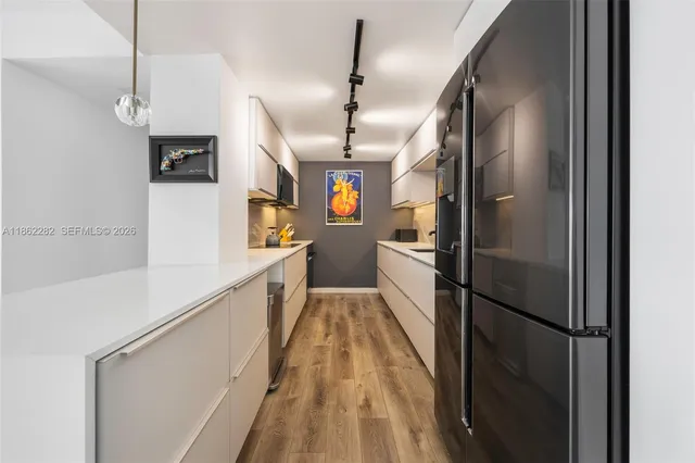 a kitchen with stainless steel appliances granite countertop refrigerator a sink and dishwasher