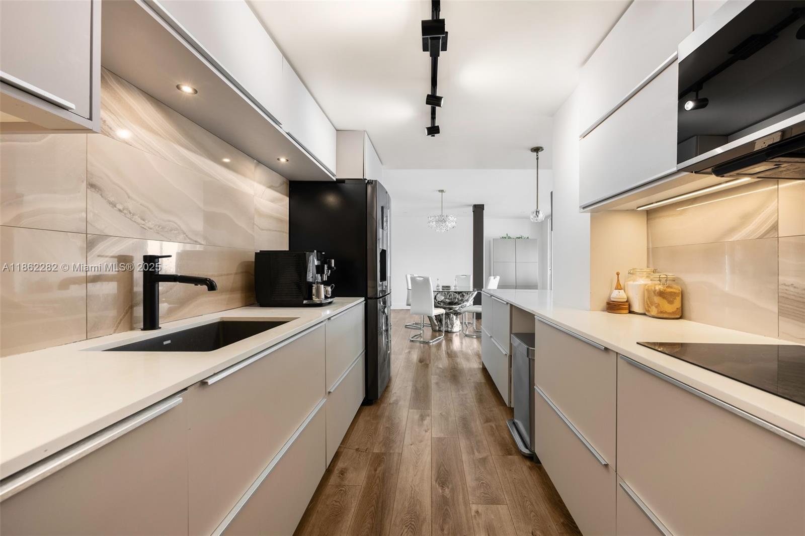 2451 Brickell Avenue, Unit 21D Miami, FL 33129 - Photo 10 of 21 a large kitchen with a large counter top appliances and cabinets