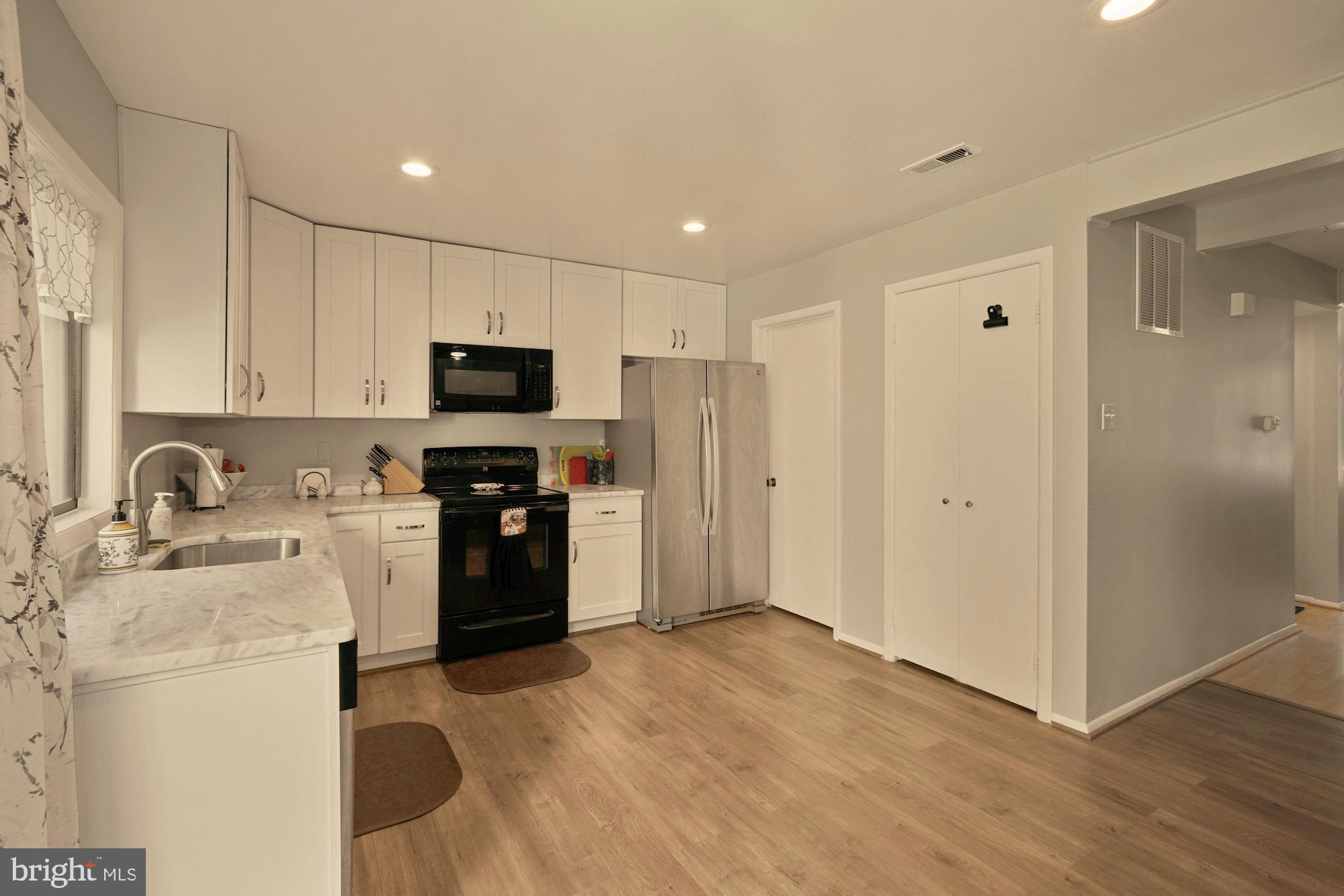 9122 Centerway Road Gaithersburg, MD 20879 - Photo 5 of 33 a kitchen with a refrigerator and a sink